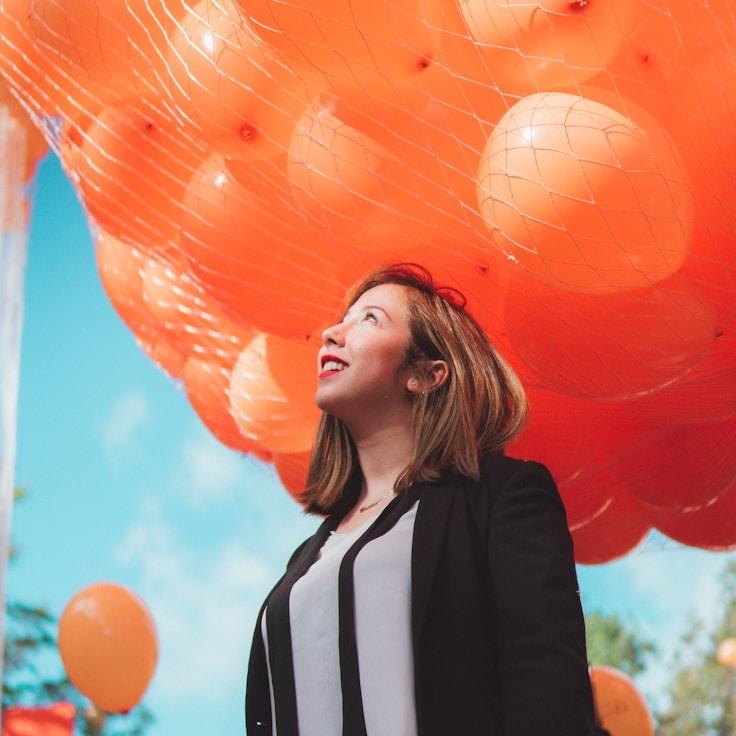 Kaveri Mehta, Lead Design Curator at Sage Bay Harbor, reviewing corporate floral arrangements
